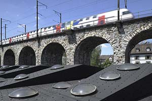 Exterior view of multiple circular Dome Rooflights installed in both flat roof and sections of sloped roof