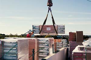 crane lifting skylights on a roof